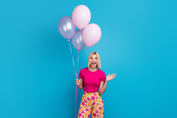 Photo portrait of attractive young woman hold amazed air balloons dressed stylish pink clothes...
