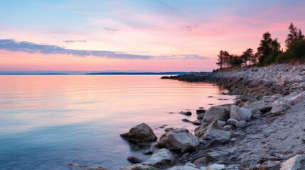 Naklejka premium Serene coastal sunrise over tranquil bay.
