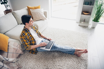 Photo of cheerful thoughtful guy dressed plaid shirt communciating instagram twitter telegram...