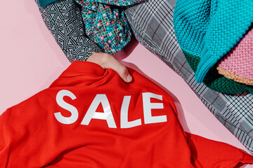 man grabbing a shirt with the word sale printed on it