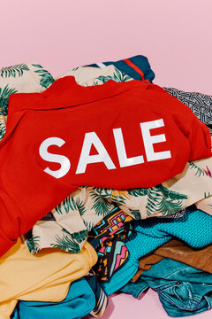 heap of clothes and shirt with the word sale printed on it