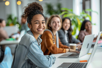 The company's employees or students are sitting and discussing the project. Young, happy, modern people of different genders and ages as members of one team.
