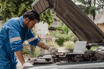 The mechanic opens the hood of the car, inspects it, repairs the car at home and provides service....