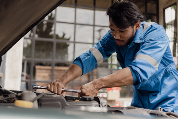 The mechanic opens the hood of the car, inspects it, repairs the car at home and provides service. Mechanic technician checking engine, car service, repair, maintenance, checking car concept