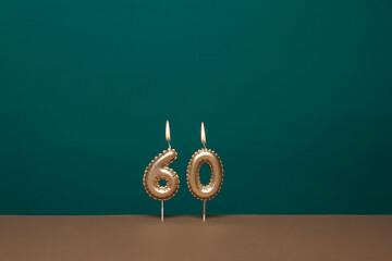 lit candles forming the number 60