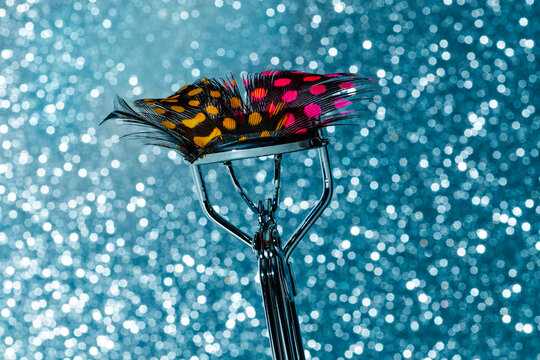 fake eyelash patterned with spots of different colors in a curler