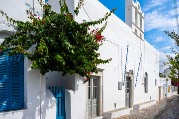 Facade of white church on street in Artemonas village, Sifnos island, Greece
