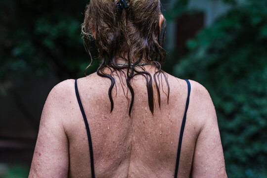 Back of senior woman with wet hair and body