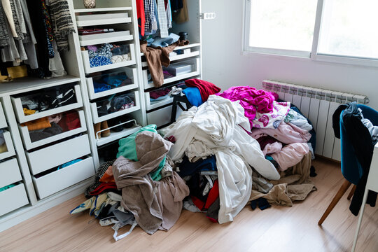 Cluttered Walk-in Closet with Clothes