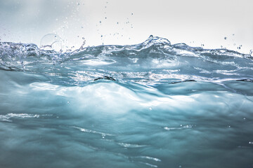 Close up of clear blue tropical wave breaking