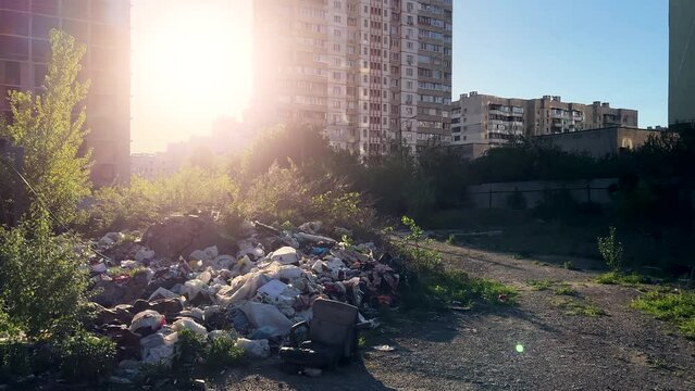 Apocalyptic Urban Wasteland: Noxious Garbage Pile Dwarfing Residential Towers at Sunset