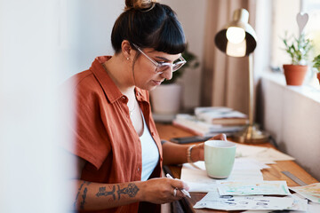 Woman, drawing and cup of coffee in workspace with papers for design project, sketch art or...
