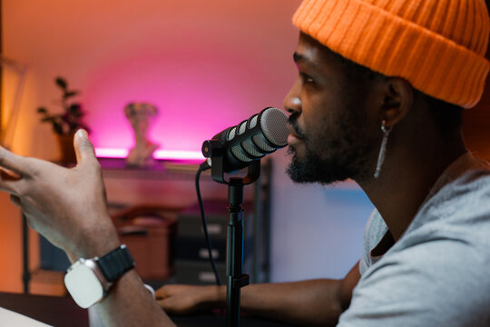 A man speaks into a microphone in the studio
