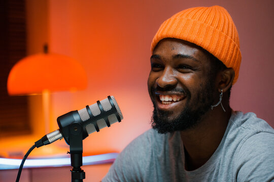 A man speaks into a microphone in the studio
