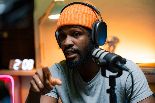 A man speaks into a microphone in the studio