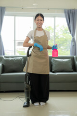 Young beautiful Asian woman doing housework and cleaning the house Happy smiling with house cleaning tools