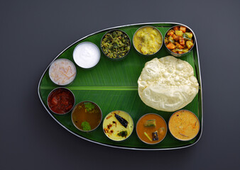 Traditional Indian meal served on a banana leaf, featuring a variety of colorful curries, rice, and bread. Represents cultural richness, diversity, and authentic culinary experience.
