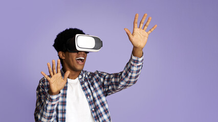 Modern Entertainment. Excited Teen Guy Enjoying Virtual Reality Glasses Experience, Pink Background