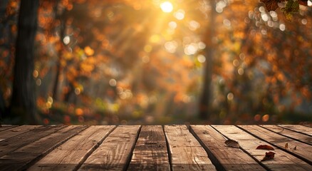A wooden table with an autumn background. The focus is on the empty tabletop, set against a blurred scene of trees and leaves in fall colors