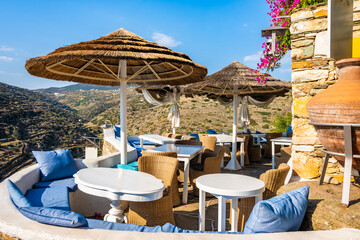 Cafe restaurant with sun umbrellas and beautiful mountain view in Kastro village, Sifnos island,...