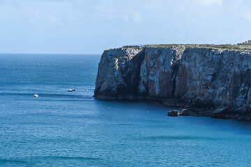 Rocky coastline in Sagres, on the Algarve coast of Portugal. Farol do Cabo de Sao Vincente