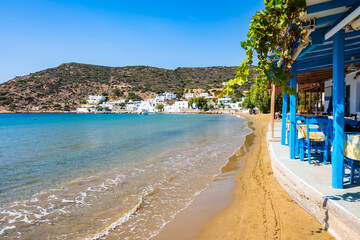 Traditional Greek taverna restaurant on sandy beach in Platis Gialos village, Sifnos island, Greece