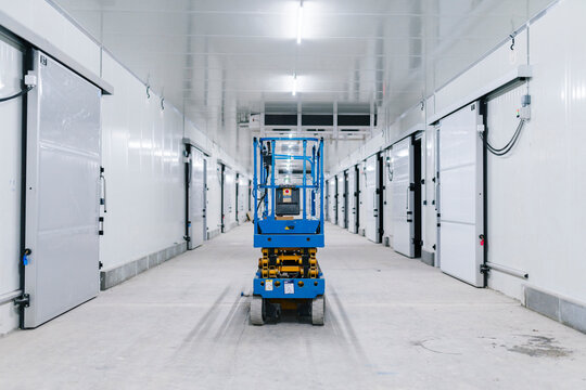 Scissors lift standing in hallway of warehouse