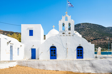 Beautiful white church on shore of sandy coast in Platis Gialos village, Sifnos island, Greece