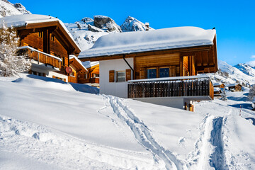 Traditional alpine wooden houses in winter mountain snow landscape, Loetschental valley, Switzerland
