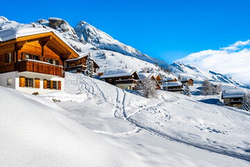 Traditional alpine wooden houses in winter mountain snow landscape, Loetschental valley, Switzerland