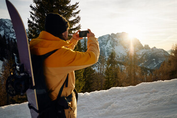 Skier photographs the mountain scenery