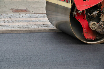 Close up of road construction asphalt roller machine at work. Heavy Vibration roller compactor at...