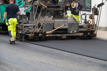 Repair of asphalt road surface - old layer removed and a coating Industrial pavement truck laying...