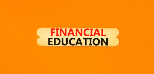 Financial education symbol. Concept words Financial education on beautiful wooden stick. Beautiful orange paper background. Business Financial education concept. Copy space.