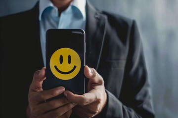 businessman pressing smiley face icon on mobile phone customer satisfaction concept