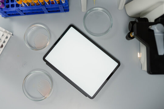 A tablet with a white screen on the laboratory assistant's desk
