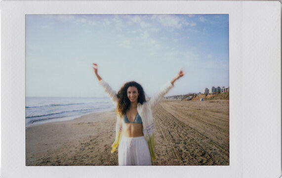 Polaroid photo scan of young happy woman at beach
