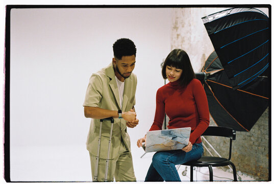 Client showing to photographer reference at studio