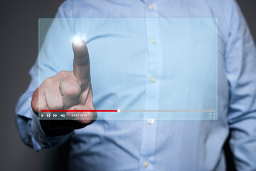 Unrecognizable man pointing at a screen of a virtual floating video player