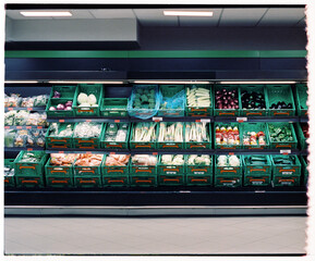 Supermarket shelves full of fresh vegetables