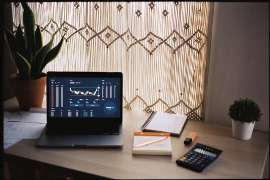 Candlestick chart on trading platform interface on laptop monitor