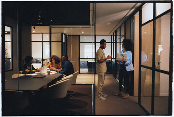 Businesspeople at modern office with meeting room