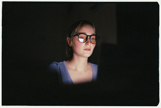 Hardworking woman using laptop late in the night