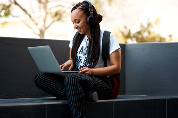 Woman, student and headset with laptop outside, typing and online classes for elearning or...
