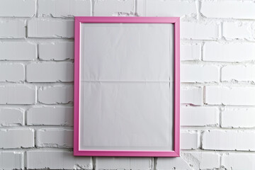 an empty poster in a pink frame on a white brick wall.