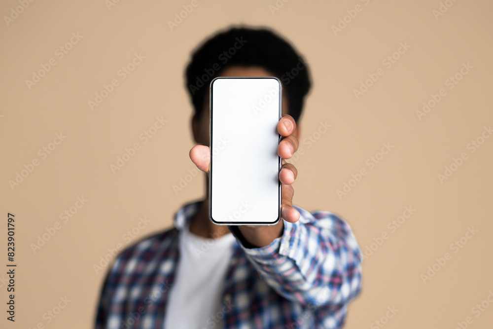 Poster mockup for app. guy demonstrating blank screen of smartphone, copy space, closeup