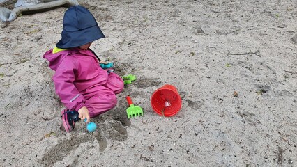 child playing on the sand