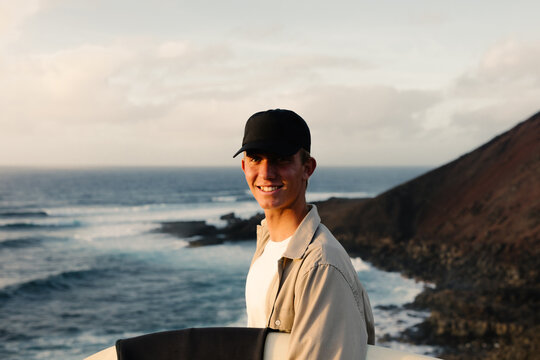 A surfer smiling because he found the right tide to surf