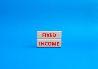 Fixed Income symbol. Concept word Fixed Income on wooden blocks. Beautiful blue background. Business and Fixed Income concept. Copy space