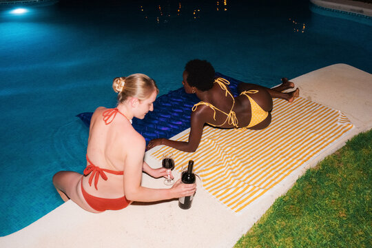 Diverse women spending time together at swimming pool